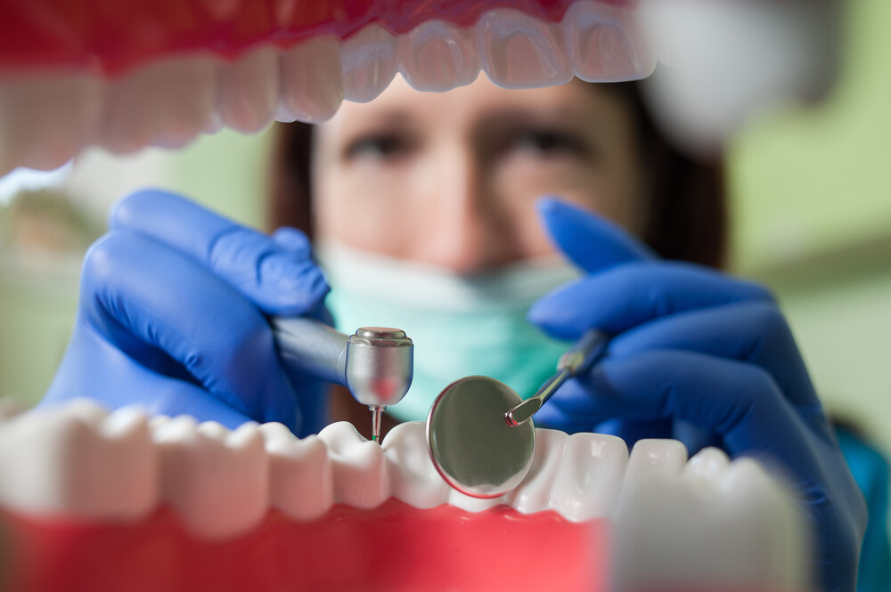 Dentist performing restorative dental treatment with advanced dental tools