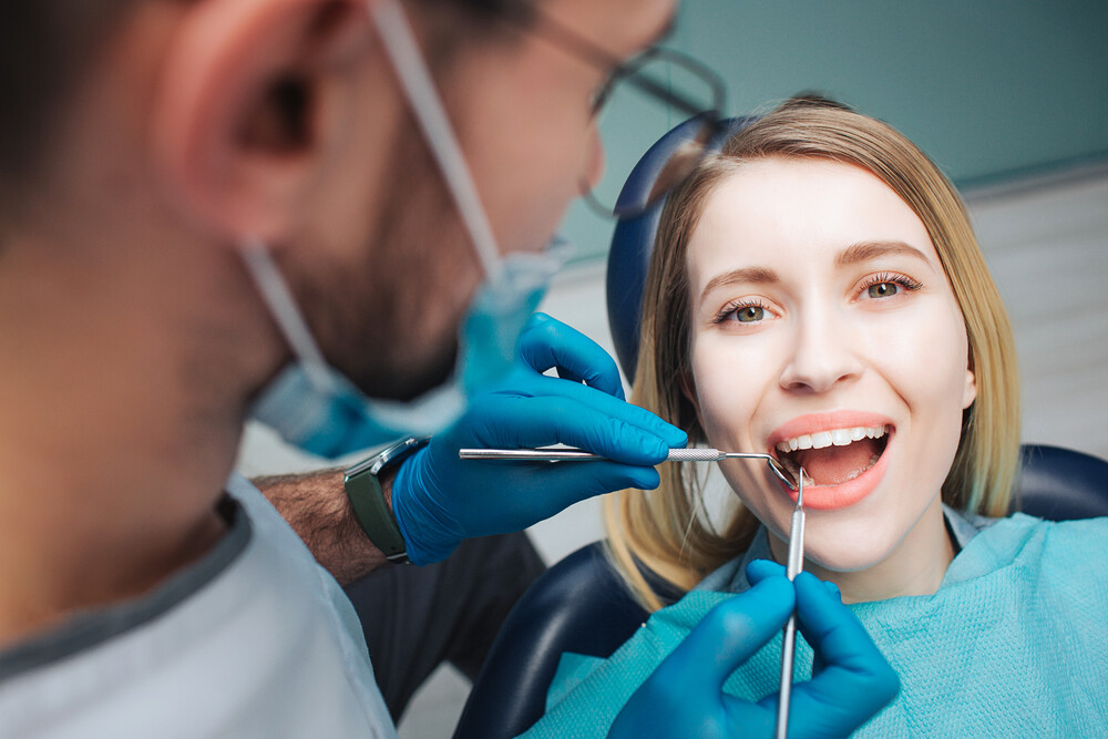 Dentist examining patient during Same Day Dental appointment
